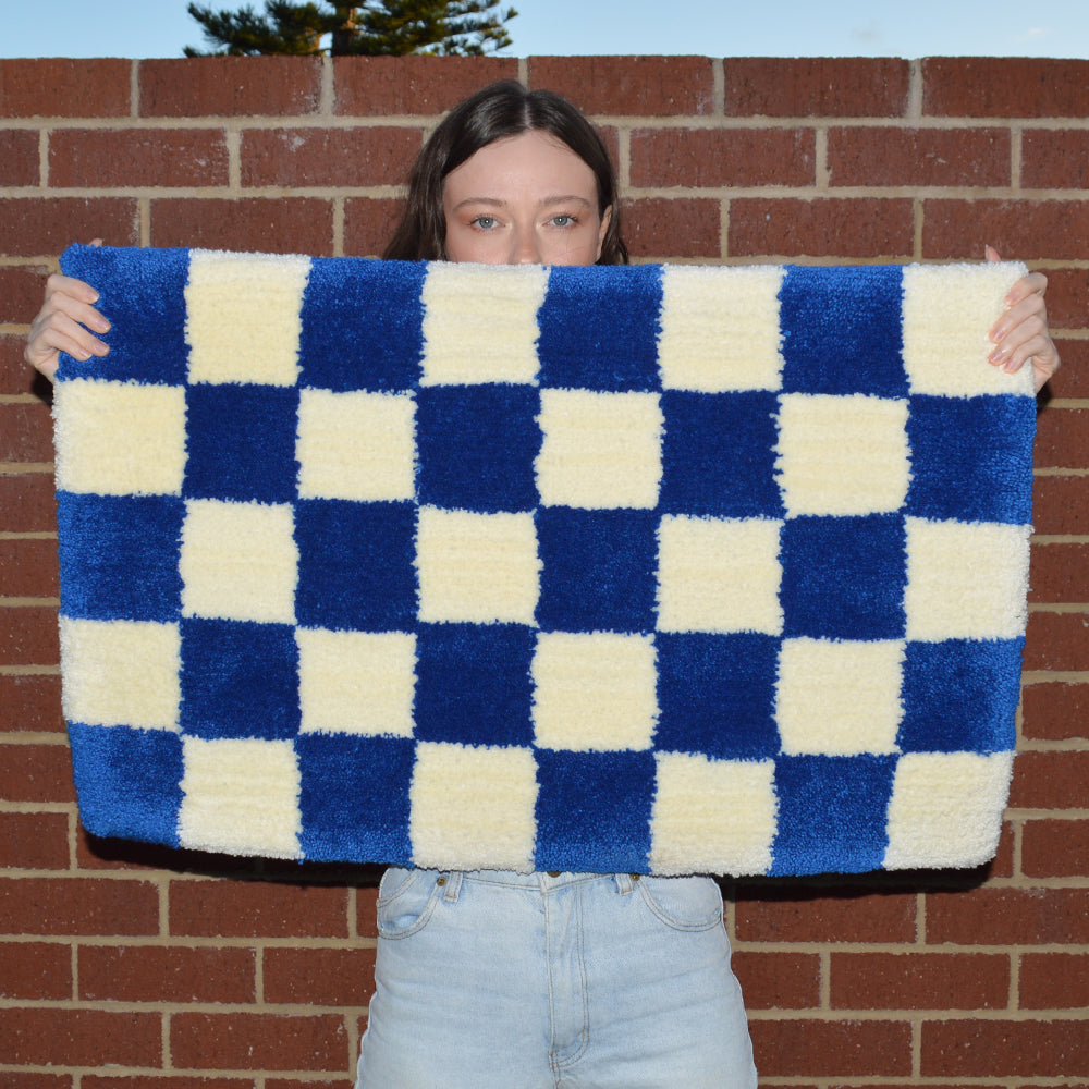 Woman Holding Casaprima Blue & Cream Checkboard Rug